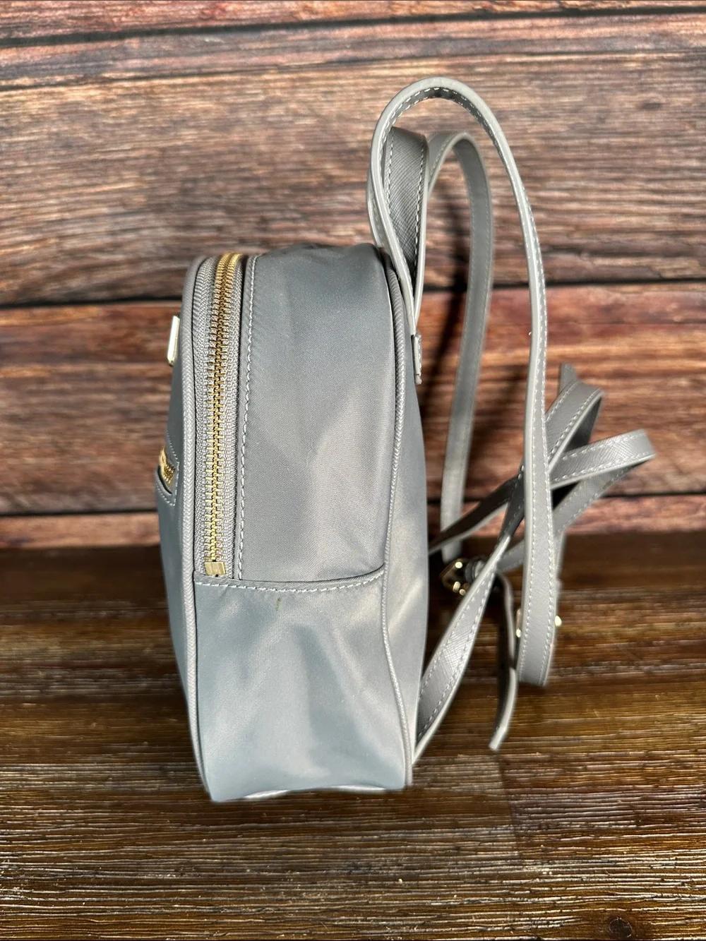 kate spade gray mini Bradley backpack with gold hardware